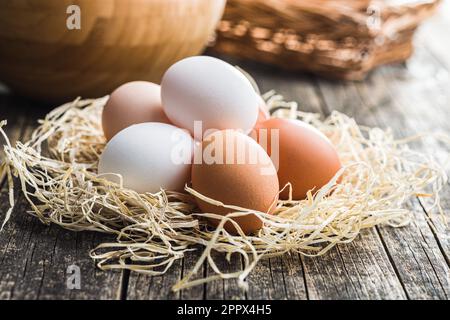 Uova intere di pollo sul tavolo di legno. Foto Stock