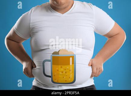 Problema alla pancia della birra. Uomo sovrappeso su sfondo blu, primo piano Foto Stock