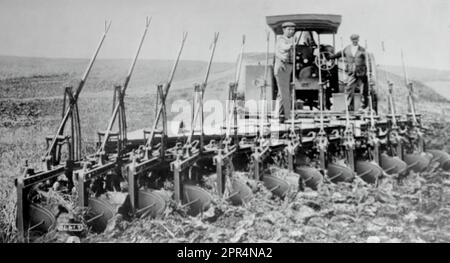 L'aratro del trattore dell'olio del solco al lavoro l'inizio del ventesimo secolo è ricordato come l'era della meccanizzazione. Era un periodo in cui l'uomo sviluppò ulteriormente il progresso della rivoluzione industriale e imparò ad adattare le forze della natura alle proprie necessità. Foto originale di Marshall, Sons and Co, Gainsborough. Non è stata ancora ridata, la fotografia risale all'inizio del ventesimo secolo, e certamente non più tardi del 1925. Foto Stock