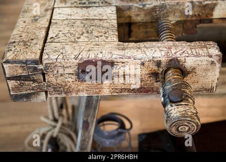 Un vecchio banco di lavoro in legno, banco di lavoro in officina. Foto Stock