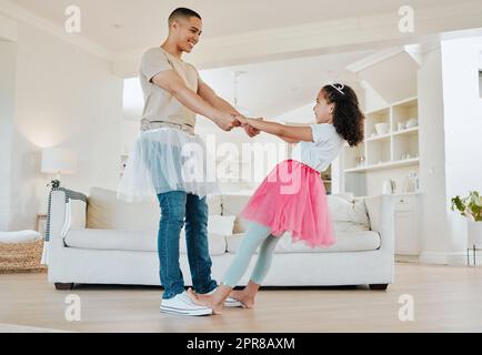 Mi fai girare a destra attorno a papà. Scatto di un padre che danzava con sua figlia nel soggiorno di casa. Foto Stock