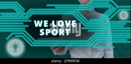 Cartello di testo che mostra We Love Sport. Idea di business per apprezzare molto le attività sportive e atletiche allenare una donna d'affari con il tablet che presenta nuove idee di comunicazione globale. Foto Stock