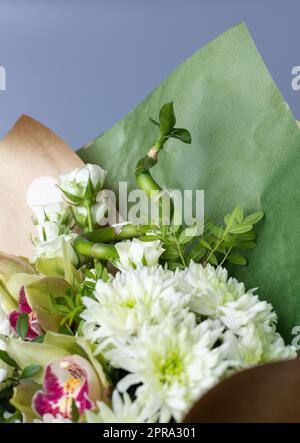 Primo piano di un bouquet di crisantemi decorati con un ramoscello verde originale. Foto Stock