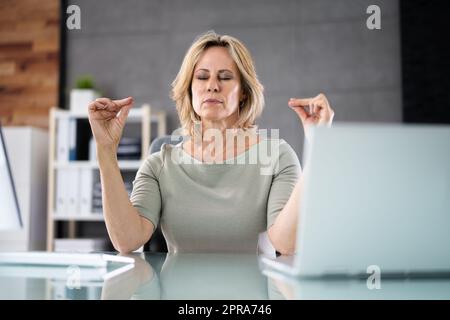 Esercizio di meditazione Yoga sana in sedia da ufficio Foto Stock