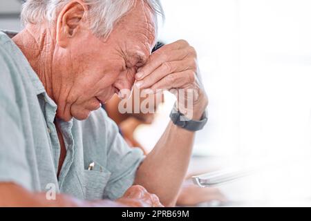 Quando fa questa fine di riunione. Un uomo d'affari maturo che osserva sollecitato in un ufficio. Foto Stock