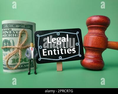 Gavel, banconote, persone in miniatura e legno con la parola entità legali Foto Stock