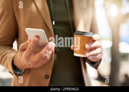 La comunicazione è fondamentale anche durante il viaggio: Un uomo irriconoscibile che invia un messaggio di testo durante il viaggio mattutino. Foto Stock