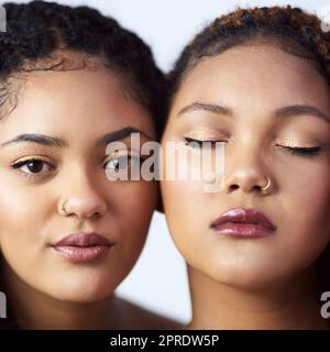 La pelle lucente e impeccabile è ciò che aspirano. Studio di due belle giovani donne in posa su uno sfondo grigio. Foto Stock