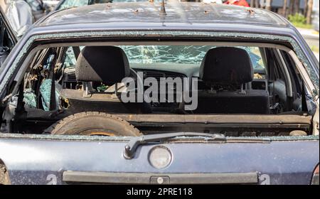 Una vettura dopo un incidente con un lunotto rotto. Finestrino rotto in un veicolo. Il relitto dell'interno di un'auto moderna dopo un incidente, una vista dettagliata ravvicinata dell'auto danneggiata. Foto Stock