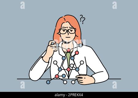 Scienziato donna seduto alla scrivania, guarda il modello di molecola. Lady in laboratorio risolve problemi di biochimica o genetica. Biochimico fa esperimenti Foto Stock