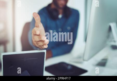 Benvenuti nel team. Un giovane uomo d'affari irriconoscibile che si avvicina a voi per una stretta di mano in ufficio. Foto Stock