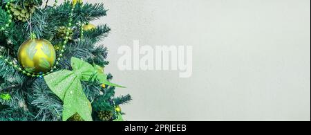 Striscione con albero di Natale decorato con archi, palline di vetro scintillante e giocattoli sull'albero di Natale da vicino con uno spazio vuoto sulla destra Foto Stock