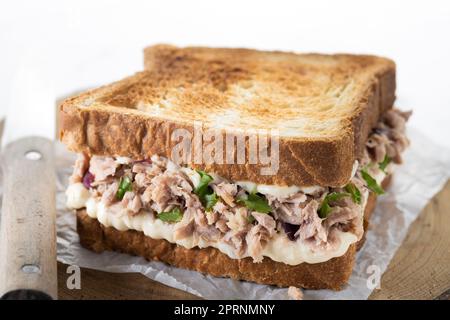 Panino di tonno con mayo e verdure su marmo bianco Foto Stock
