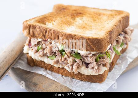 Panino di tonno con mayo e verdure su marmo bianco Foto Stock