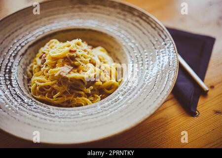 Primo piano shot di spaghetti alla carbonara in un piatto. Foto Stock