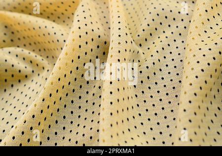 Maglia sportiva gialla tessuto texture e sfondo con molte pieghe Foto Stock