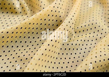 Maglia sportiva gialla tessuto texture e sfondo con molte pieghe Foto Stock