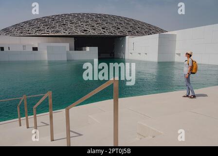 Abu Dhabi, Emirati Arabi Uniti - 21 marzo 2023 : viaggiatore femminile vicino al museo del Louvre ad Abu Dhabi, Emirati Arabi Uniti. Il Louvre è un nuovo museo negli Emirati Arabi Uniti aperto il 8th 2017 novembre Foto Stock
