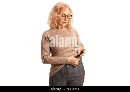 Donna matura che inietta insulina iniettata nella pancia isolata su sfondo bianco Foto Stock