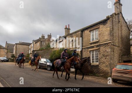 Middleham, Wensleydale, North Yorkshire. Cavalli da corsa che percorrono le strade della città dopo le galoppe mattutine. Foto Stock