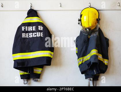 Un costume da supereroe dei fuochi d'artificio. abbigliamento per vigili del fuoco appeso a una parete Foto Stock