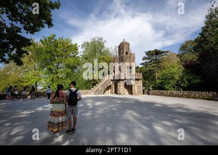 Si vedono persone che camminano lungo le mura dei giardini principali di Quinta da Regaleira. Il Quinta da Regaleira è una proprietà situata nel centro storico del villaggio di Sintra, vicino alla città di Lisbona. Fu costruito tra il 1898 e il 1913. Si tratta di un monumento culturale classificato come Patrimonio Mondiale dell'Umanità dall'UNESCO. Foto Stock