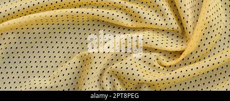 Maglia sportiva gialla tessuto texture e sfondo con molte pieghe Foto Stock