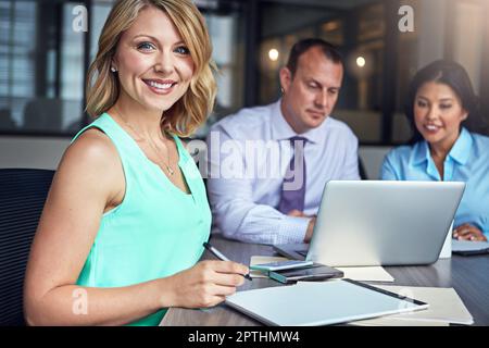 Stavano avendo una riunione realmente produttiva. Ritratto di una donna d'affari che ha un incontro con i suoi colleghi nella sala del consiglio. Foto Stock