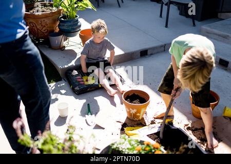 Nipoti che piantano con zio per la primavera a San Diego Foto Stock