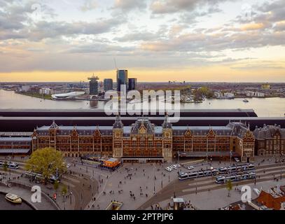 La stazione centrale di Amsterdam è un centro di trasporto con un'architettura impressionante. Offre accesso a vari modi di trasporto e ha negozi, res Foto Stock