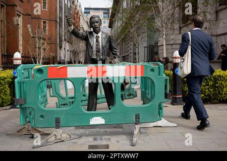 La scultura di J. Seward Johnson Jr, intitolata 'Taxi' (1993) su John Carpenter Street, circondata da barriere protettive all'esterno dell'edificio Unilever a Blackfriars nella City of London, il quartiere finanziario della capitale, il 27th aprile 2023, a Londra, Inghilterra. 'Taxi' mostra un lavoratore cittadino con una mano, con un taxi. È uno dei 6 cast dell'artista americano e erede di Johnson & Johnson. Foto Stock