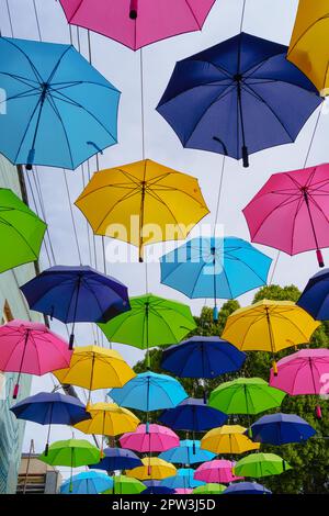 Guarda una fila di ombrelloni colorati nel centro di Redlands, California, USA Foto Stock