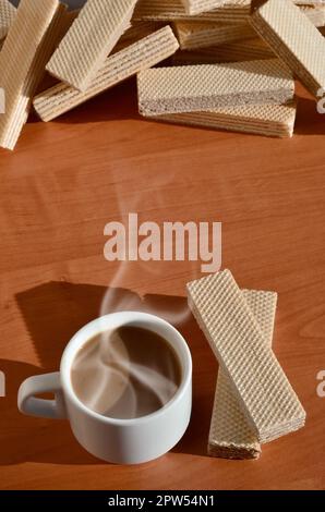 Una tazza di caffè caldo e una manciata di classico russo cialde con diversi riempimenti su un marrone la superficie di legno. Still-life di mattina festa, concetto s Foto Stock