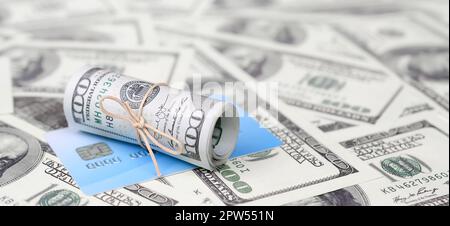 US dollari arrotolato e serrato con la band si trova sulla carta di credito. Il denaro americano e moderna online virtual banking concept Foto Stock