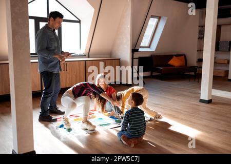 Famiglia felice divertirsi insieme, quattro bambini giocare twister gioco a  casa Foto stock - Alamy