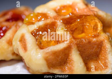 Primo piano con waffle freschi e deliziosa marmellata di ananas. Preparare cibo fatto in casa o dessert a casa Foto Stock