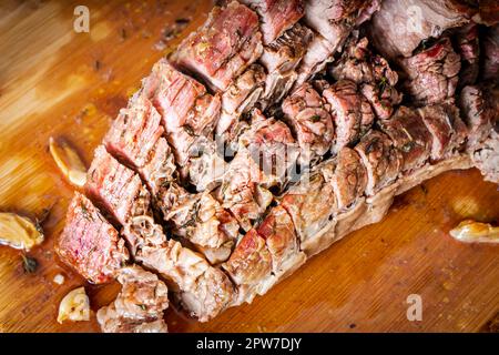 FLANK STEAK Beef BBQ food. Carne arrosto con patate e timo su un asse di legno, completamente tagliata a fette. Foto Stock