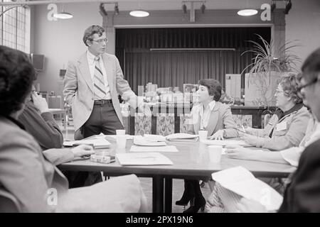 1970S UOMO IN PIEDI CHE PARLA CON UN PICCOLO GRUPPO DI INSEGNANTI NELLA SCUOLA AUDITORIUM - S21235 HAR001 HARS GRADO TESTA E SPALLE DISCOVERY ISTRUTTORE CONOSCENZA OCCUPAZIONI CONNESSIONE PRIMARIA AUDITORIUM EDUCATORE ELEGANTE SOSTEGNO COOPERAZIONE EDUCATORE EDUCATORI SCUOLA DI GRADO ISTRUTTORI MID-ADULTI MID-ADULT UOMO MID-ADULT LA SCUOLA FEMMINILE INSEGNA ETNIA CAUCASICA BIANCA E NERA HAR001 VECCHIO STILE Foto Stock