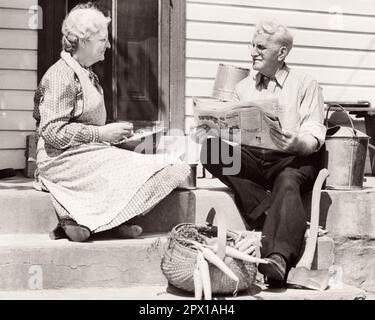 1940S DONNA UOMO ANZIANO SEDUTA SU GRADINI DA PORTA SCHERMO CHE STRAPPA FAGIOLI CHE LEGGE CESTINO GIORNALE FRESCO CAROTE RACCOLTE - F1499 HAR001 HARS LIFESTYLE SODDISFAZIONE ANZIANO FEMMINE SPOSATE SPOSI RURALI MARITI SPOSI HOME VITA COPIA SPAZIO AMICIZIA METÀ LUNGHEZZA SIGNORE PERSONE AGRICOLTURA MASCHI FAGIOLI PENSIONE ANZIANO ADULTO AGRICOLTURA B&W PARTNER SENIOR DONNA FRESCO PENSIONATO VECCHIAIA OLDSTERS OLDSTER ESTERNO COLTIVATORI ANGOLO BASSO LEI OCCUPAZIONI HA SCELTO ANZIANI COLLEGAMENTO CONCETTUALE CAROTE UOMO ANZIANO CHE SCHIAFFO COOPERAZIONE ANZIANA DONNA RILASSAMENTO INSIEME MOGLI BIANCO E NERO Foto Stock