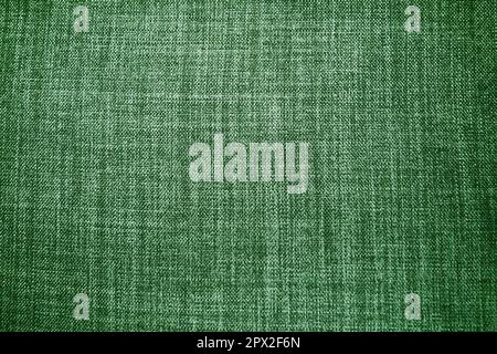 tessuto di sfondo verde. Un pezzo di panno di lana è disposto ordinatamente sulla superficie. Tessitura e tessitura tessile. Abito tessuto o per ginocchio cucina Foto Stock