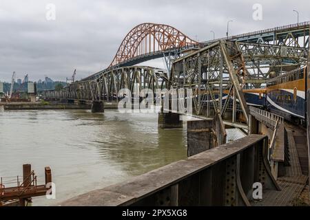 Treno Rocky Mountaineer che attraversa il ponte ad arco di Pattullo e il fiume Fraser tra New Westminster e Surrey, British Columbia, Canada. Foto Stock