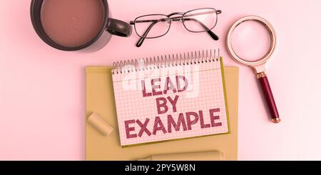 Scrittura a mano del testo Lead by example. Concetto di business essere un leader mentore seguire le regole dare esempi Coach Foto Stock