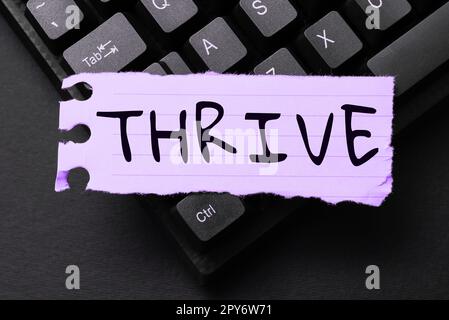 Segno che mostra THRIVE. Parola scritta su Think continuare positivamente a prosperare e fiorire il tempo di fiorire Foto Stock