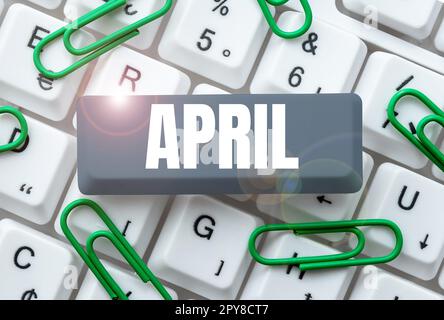 Firma scritta a mano aprile. Parola scritta su boccioli di apertura dei fiori della stagione primaverile quarto mese dell'anno Foto Stock