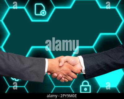 Due uomini in tuta che stringono la mano davanti a uno sfondo futuristico con bagliore colorato. Nuove tecnologie digitali del futuro. La stretta di mano rappresenta un accordo. Foto Stock