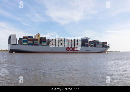 Stade, Germania – 1 maggio 2023: Nave container OOCL Spagna passando Stadersand sul fiume Elbe in direzione di Amburgo. A partire da oggi la nave è l'ultima nave Foto Stock