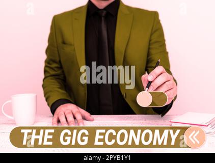 Scrittura a mano del testo The Gig Economy. Foto concettuale mercato dei contratti a breve termine lavoro indipendente temporaneo Foto Stock