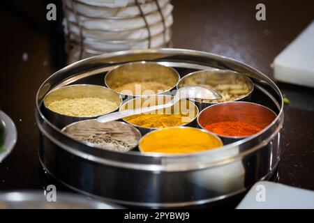 Modo tradizionale di preparare cibo indiano - erbe fresche e spezie. Foto della tradizionale lezione di cucina indiana a Goa Foto Stock