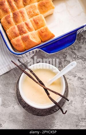 Buchteln, panini dolci fatti di pasta lievitata con latte e burro, serviti con salsa alla vaniglia Foto Stock