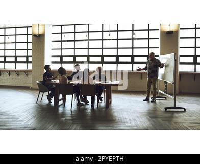 Innovare nel modo migliore, insieme. un gruppo di colleghi che hanno una riunione di ufficio all'interno. Foto Stock